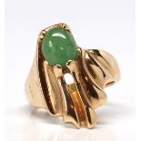 Jade, 14k yellow gold ring Featuring (1) oval jadeite cabochon, measuring approximately 8.3 X 7.0