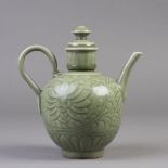 A Chinese porcelain celadon tea pot stylized with imprinted floral and tendril motif, a high loop