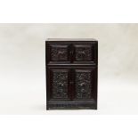A Chinese hardwood cabinet, of rectangular form with four doors and four drawers, each door is
