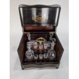 A period Louis Philippe ebonized rosewood tantalus, the exterior with brass marquetry and mother
