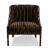 A Palecek designer lounge chair, having a faux bamboo frame of wing back form with striped