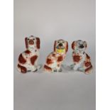 (lot of 3) English Staffordshire spaniels, each in russet red and cream, depicting seated, two