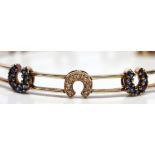 Diamond, sapphire, 14k yellow gold horseshoe bracelet