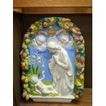 An Italian Della Robbia style ceramic arch of Madonna and Child