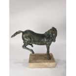 Patinated metal sculpture of a bucking horse
