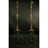 A pair of Baroque style iron and brass torchieres