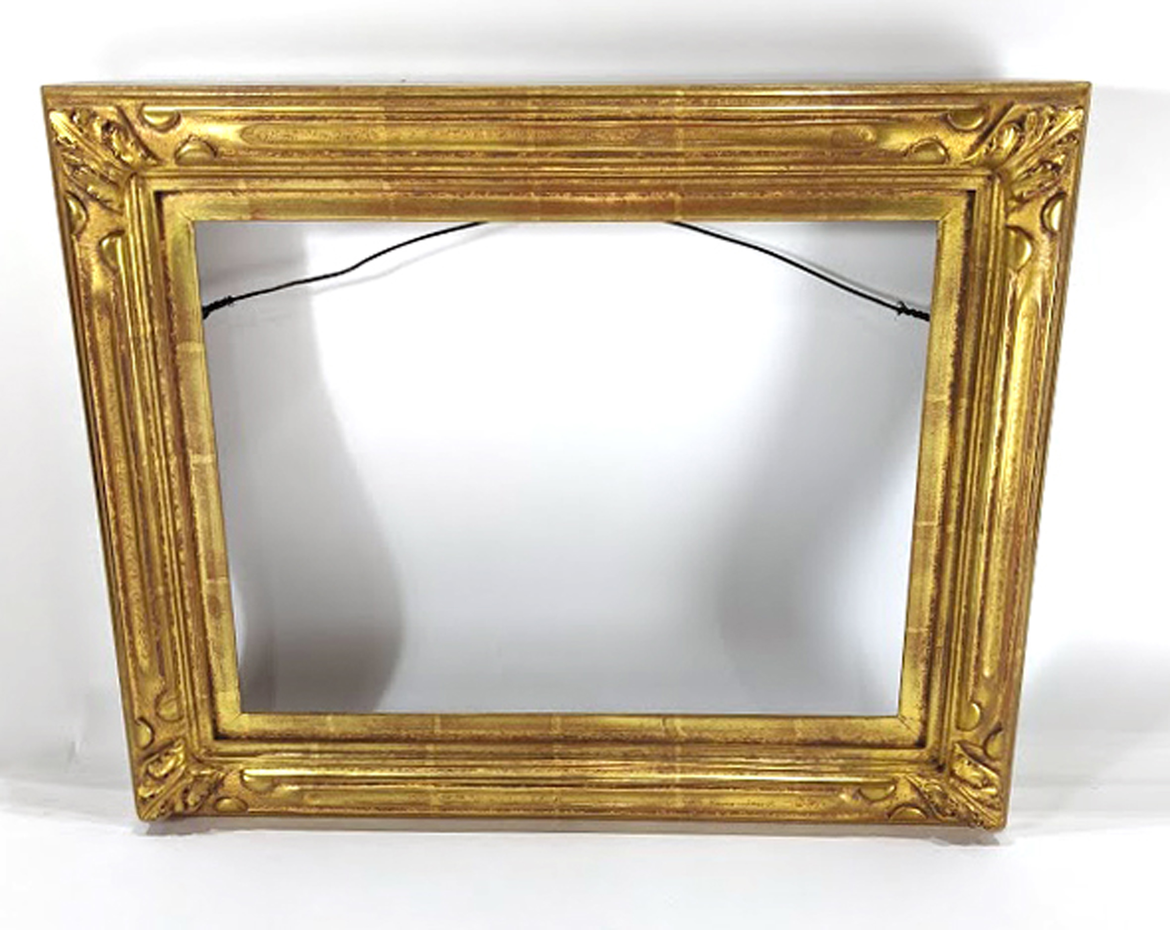 A custom giltwood carved plein air picture frame