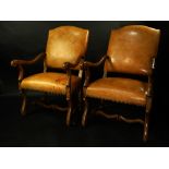 A pair of Louis XIV style style walnut leather upholstered armchairs