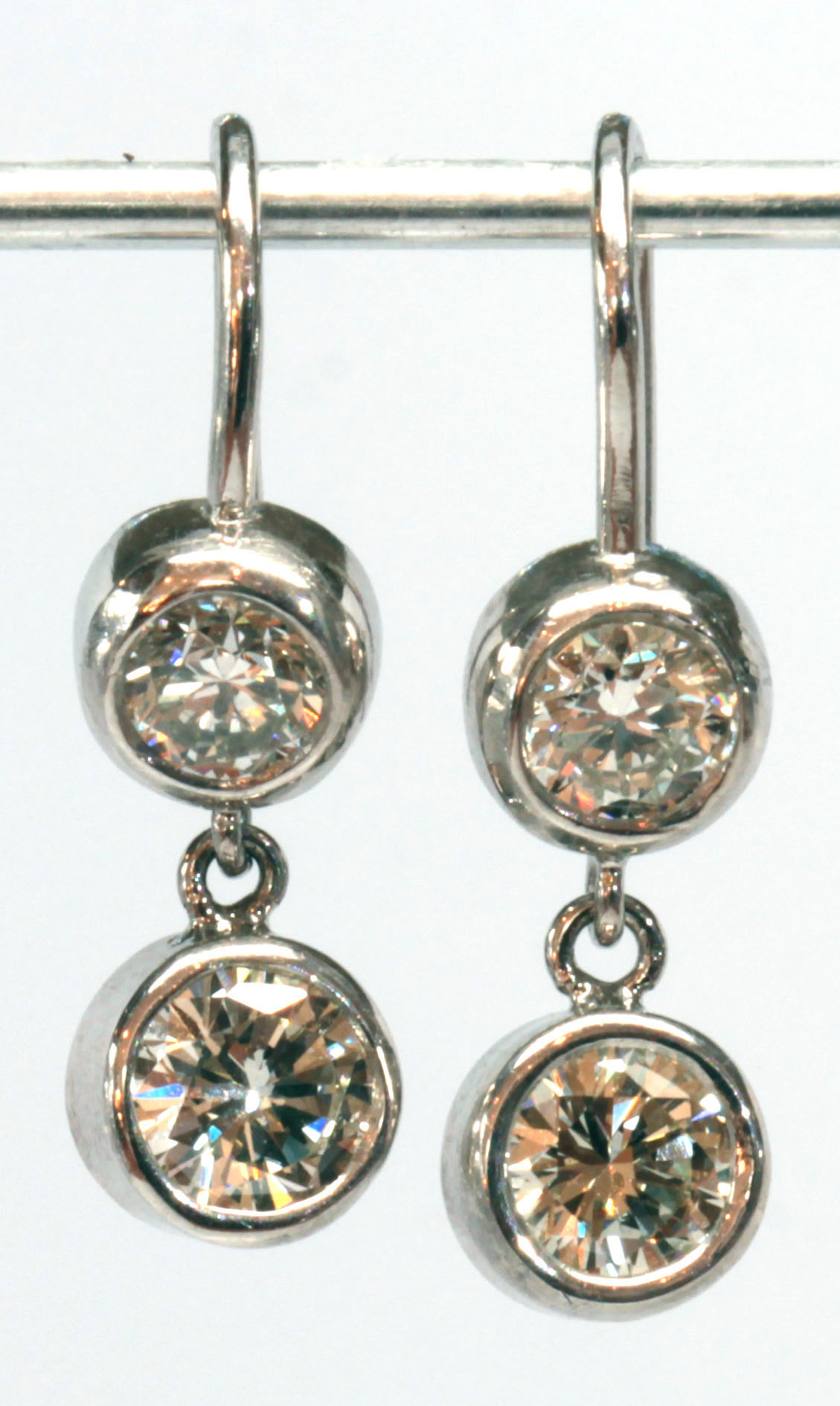 Pair of diamond, platinum, 14k white gold earrings