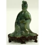 A Chinese Hardstone Guanyin, a seated Guanyin with a wood stand