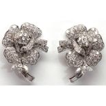Pair of diamond, 18k white gold flower earrings