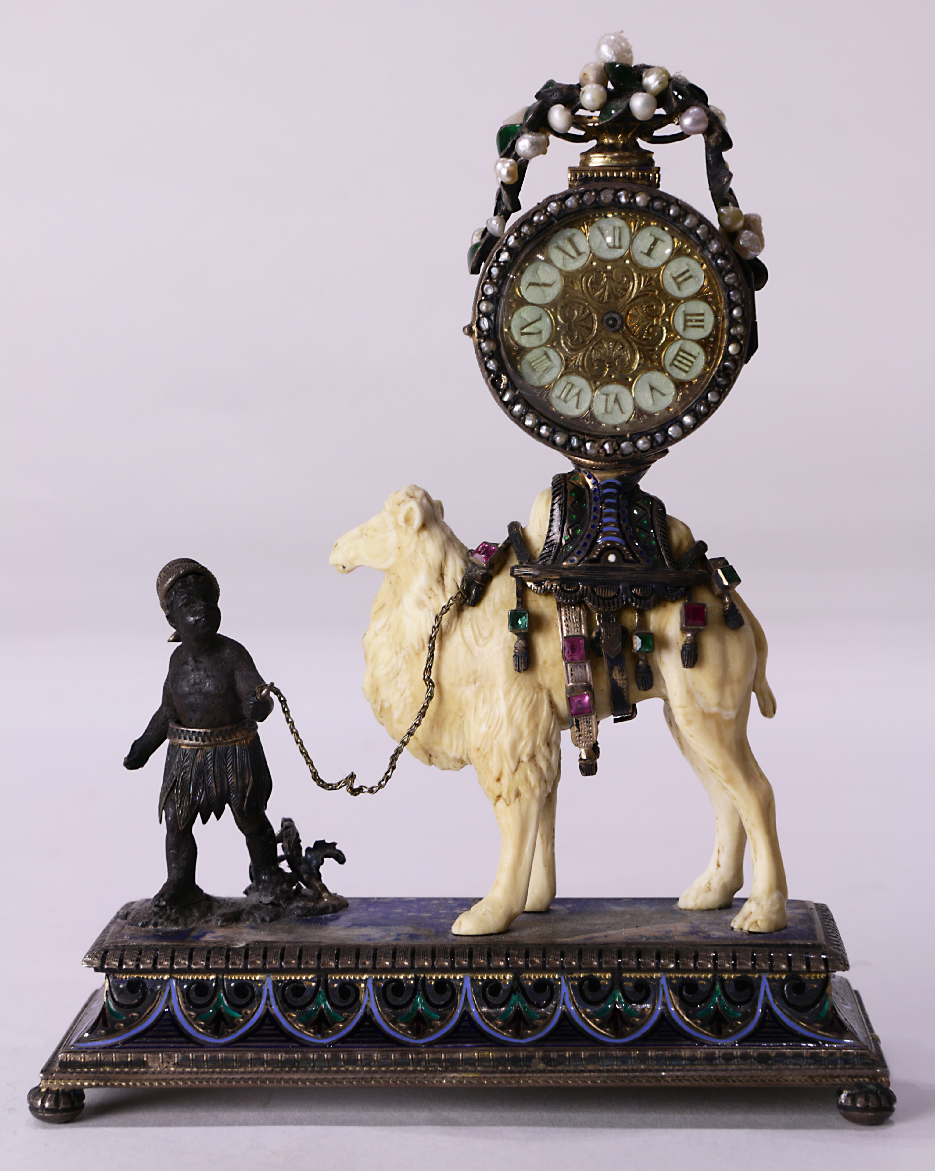 A continental emerald ruby seed pearl and eglomise decorated desk clock in the Moorish taste