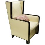 An Art Deco style ebonized wood wing back chair