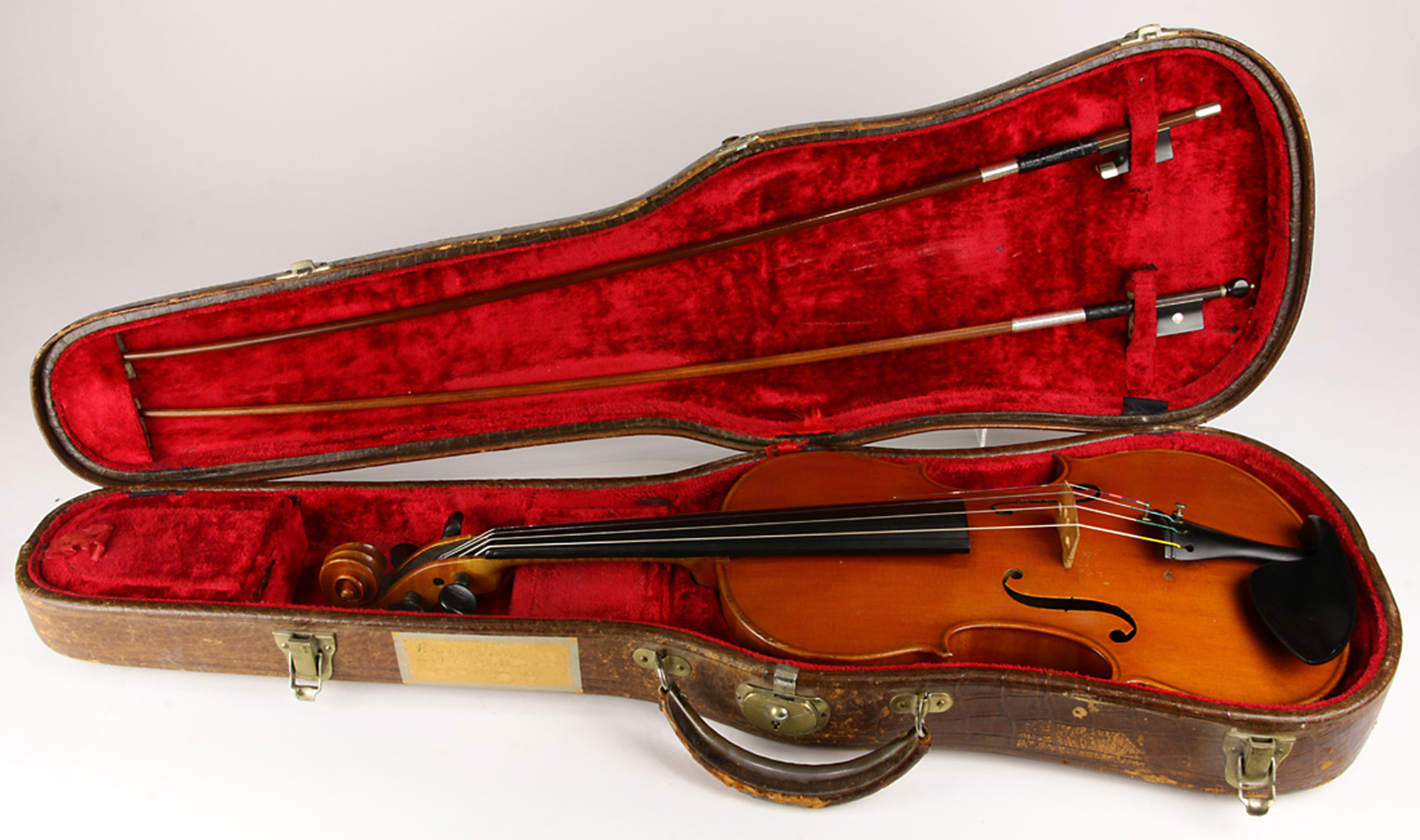 A full size violin labeled Eugene Gartner and initialed E.G upper block