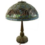 An Arts & Crafts leaded glass and patinated bronze table lamp