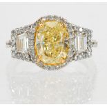 Natural fancy light yellow diamond, diamond and 18k white and yellow gold ring