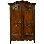 A Louis XV Provincial carved and marquetry decorated armoire