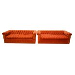 A Pair of John Stuart orange velvet upholstered Chesterfield style sofas