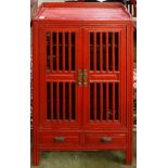 A Chinese paint decorated storage cabinet