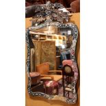 Venetian mirror, having a shaped looking glass