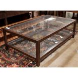 Contemporary two-tiered glass top coffee table, 54"w x 17"h