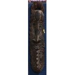Papua New Guinea flat black plaque decorated with a carved face
