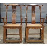 A pair of Chinese elmwood yoke-back chairs