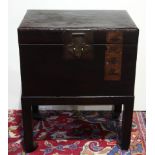 Chinese black lacquered pigskin chest on stand