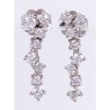 Pair of diamond, 18k white gold earrings