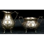 (lot of 2) Gorham sterling footed creamer and sugar with repousse floral and scrollwork