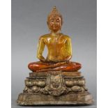 Asian sculpture of a Seated Buddha fabricated of amber colored composite material