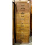 An Arts & Crafts style oak four drawer file cabinet
