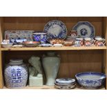 Two shelves of Asian ceramics including a blue and white ginger jar