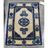 Small Chinese ivory ground rug with cobalt blossom medallions