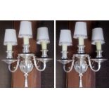 A pair of Hollywood Regency style silvered wall sconces