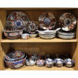 Two shelves of Imari porcelain