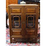 Chinese inlaid walnut cabinet with twin paneled doors centering glazed panels