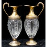 A pair of Continental Neoclassical style silver gilt mounted glass claret jugs