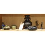 One shelf with Asian metalwork