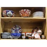 Two shelves of Japanese Kutani and Imari