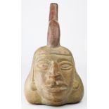 A Pre-Columbian style portrait terracotta stirrup vessel