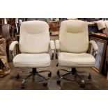 A pair of white leather chairs