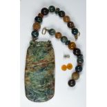 Carved stone bead, metal necklace