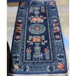 Chinese Baotou blue and ivory runner with floral arrangements and center fretwork medallion