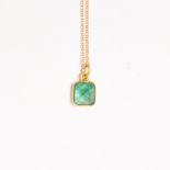 An emerald and eighteen karat gold pendant necklace