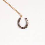 A diamond, eighteen karat gold and blackened silver pendant necklace