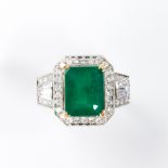 An emerald, diamond and eighteen karat white gold ring