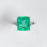 An emerald, diamond and platinum ring