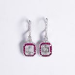 A ruby, diamond and eighteen karat white gold earrings