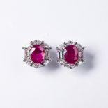 A pair of ruby, diamond and eighteen karat white gold earrings